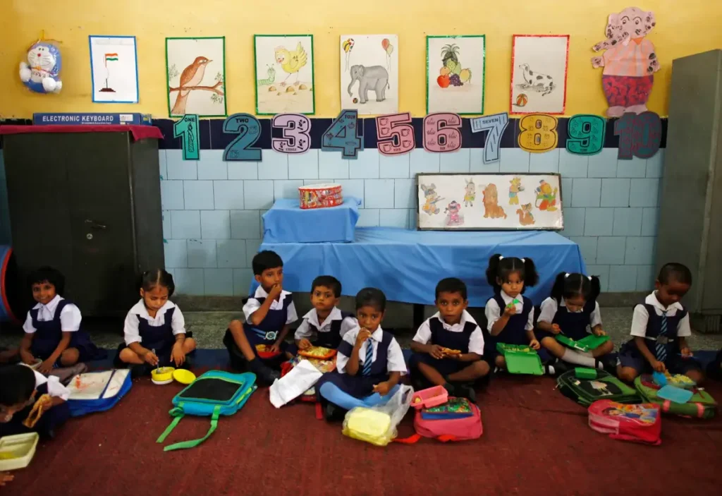 A child engaging in learning activities at a home-based preschool in India.