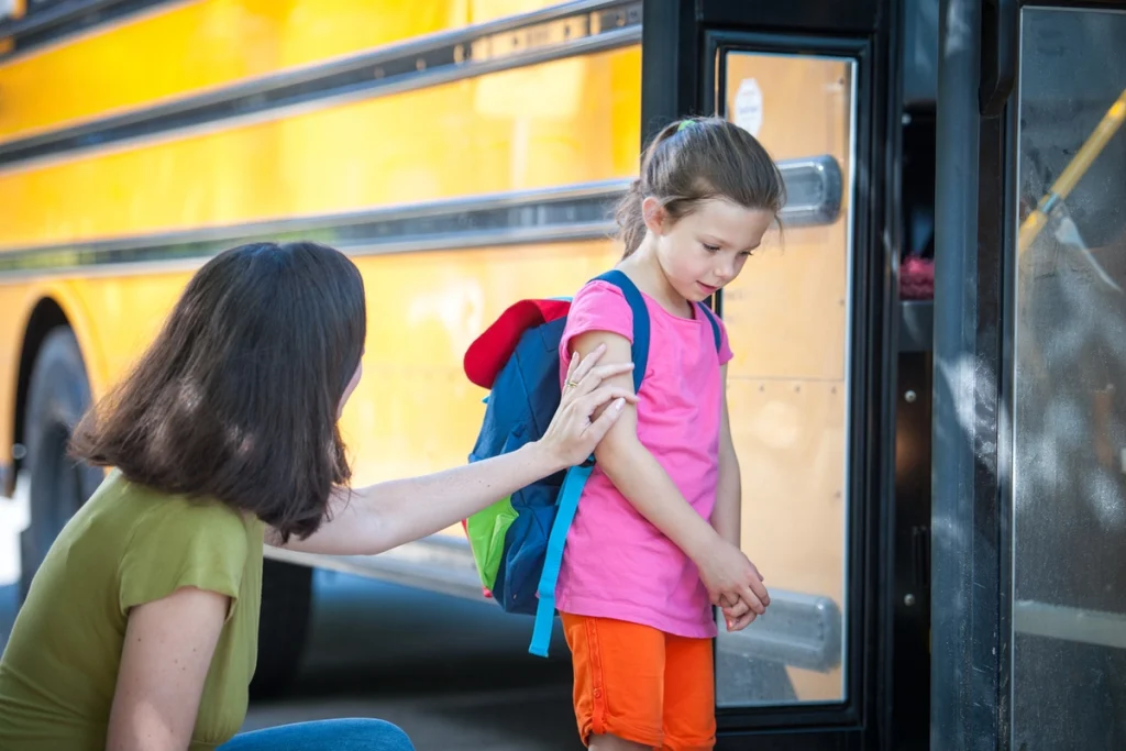 A parent guiding their shy child to interact confidently in social settings.