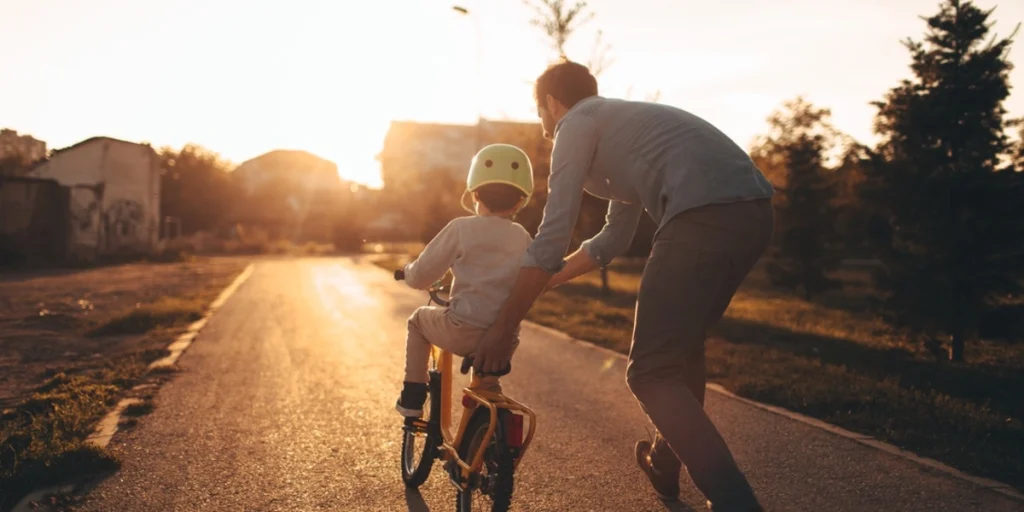 Parent helping toddler develop a growth mindset with nurturing guidance.