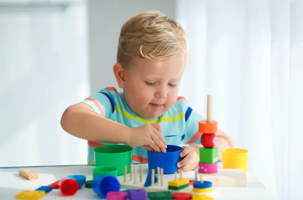 A toddler engaging in a hand-eye coordination activity to develop motor and cognitive skills.