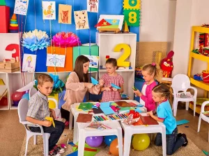 A bright and engaging preschool classroom with safe play areas, interactive learning zones, and happy children exploring activities.