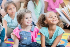 A toddler engaged in storytelling, developing language and communication skills through interactive narration.